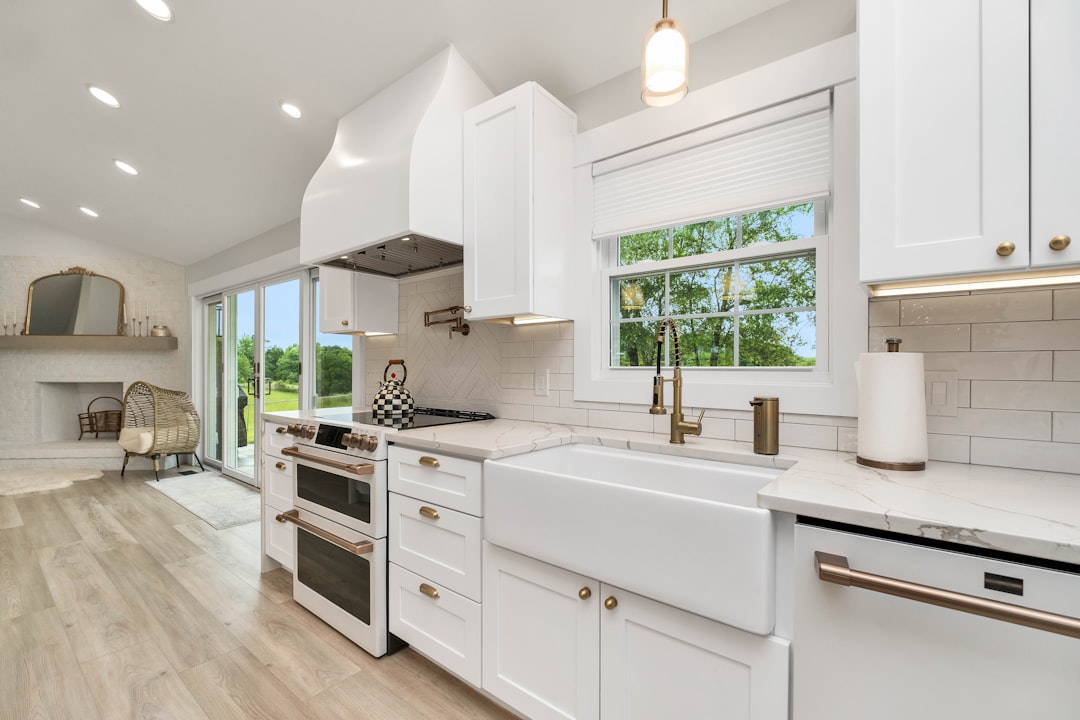 a-kitchen-with-white-cabinets-and-a-large-window-lc-6dnwo6-g